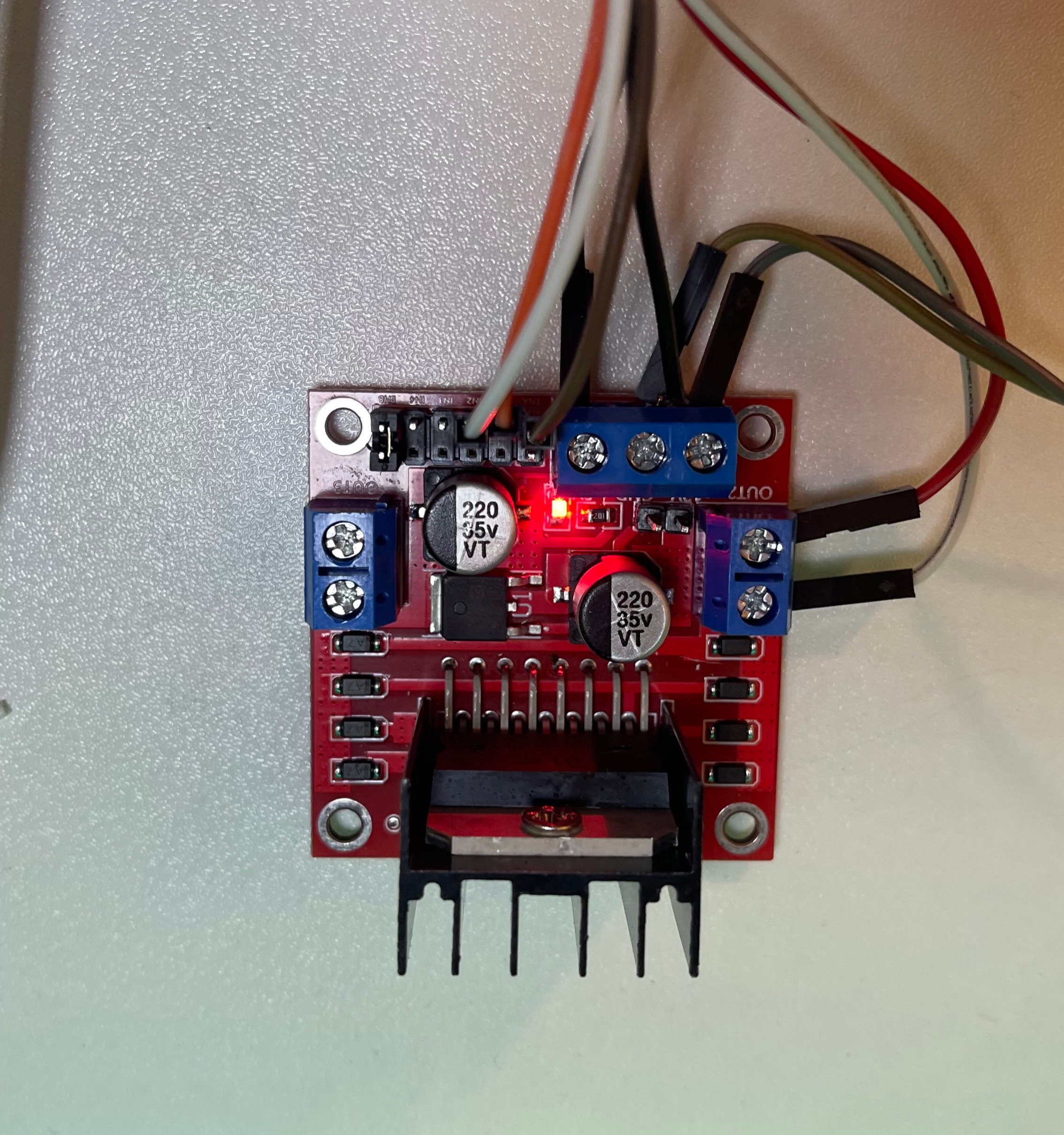 L298N H-bridge motor driver, the red breakout board, wired into the rig