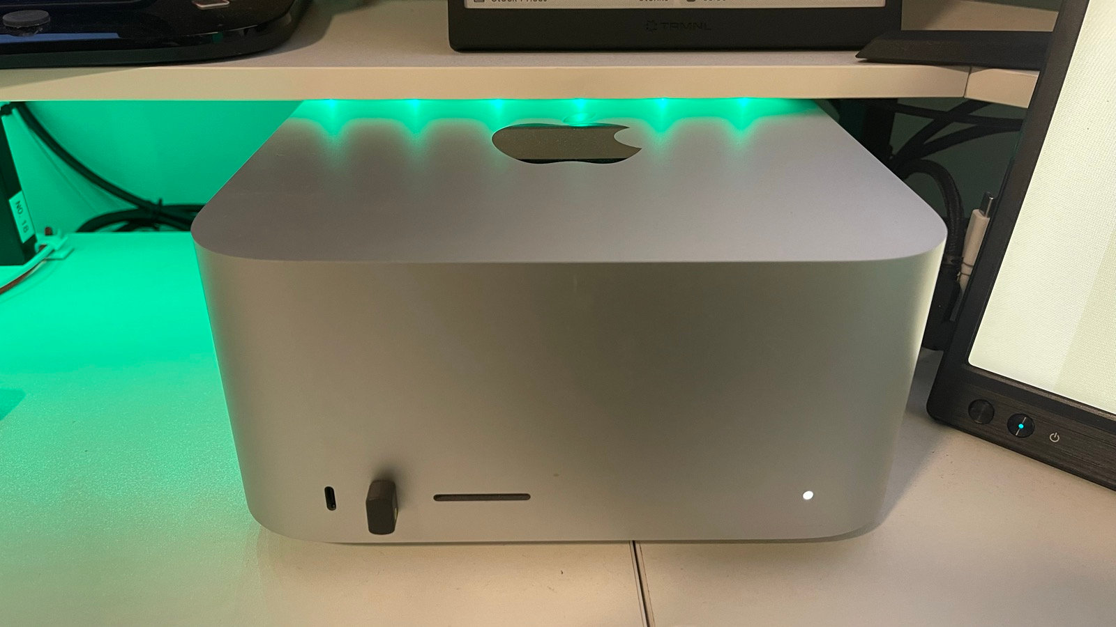 Mac Studio M3 Ultra on the author's desk, tucked under a monitor shelf